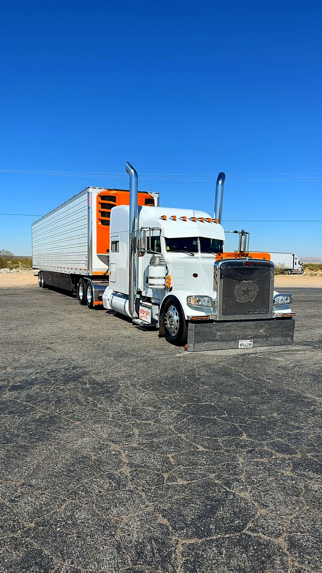 Rockstar Trucking Peterbilt with refrigerated trailer under a clear blue sky