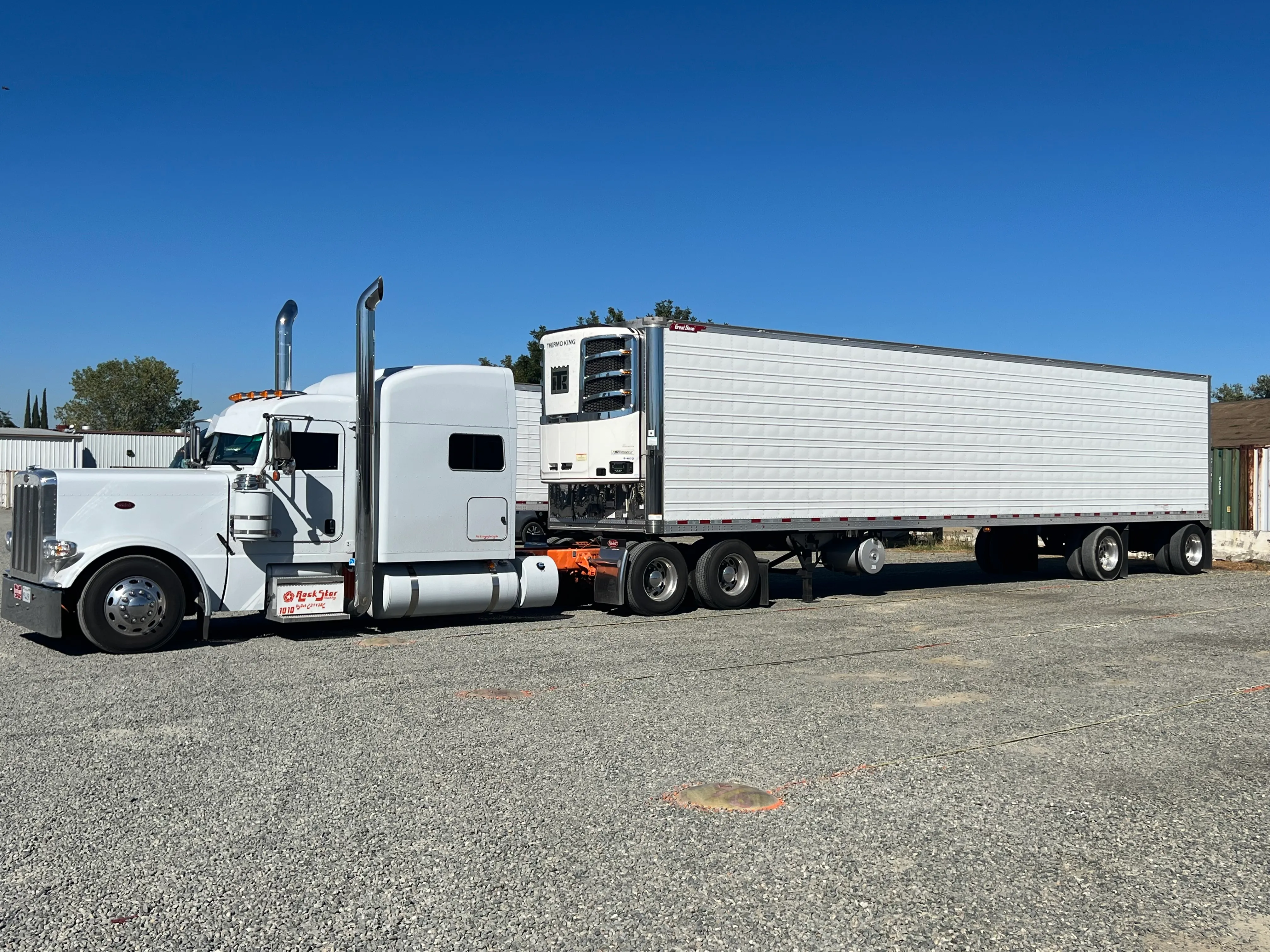 Rockstar Trucking Peterbilt and refrigerated trailer staged in the yard